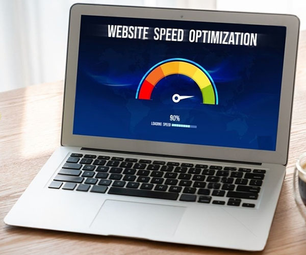 Business owner viewing redesigned website with improved metrics on laptop showing faster speed and higher conversions